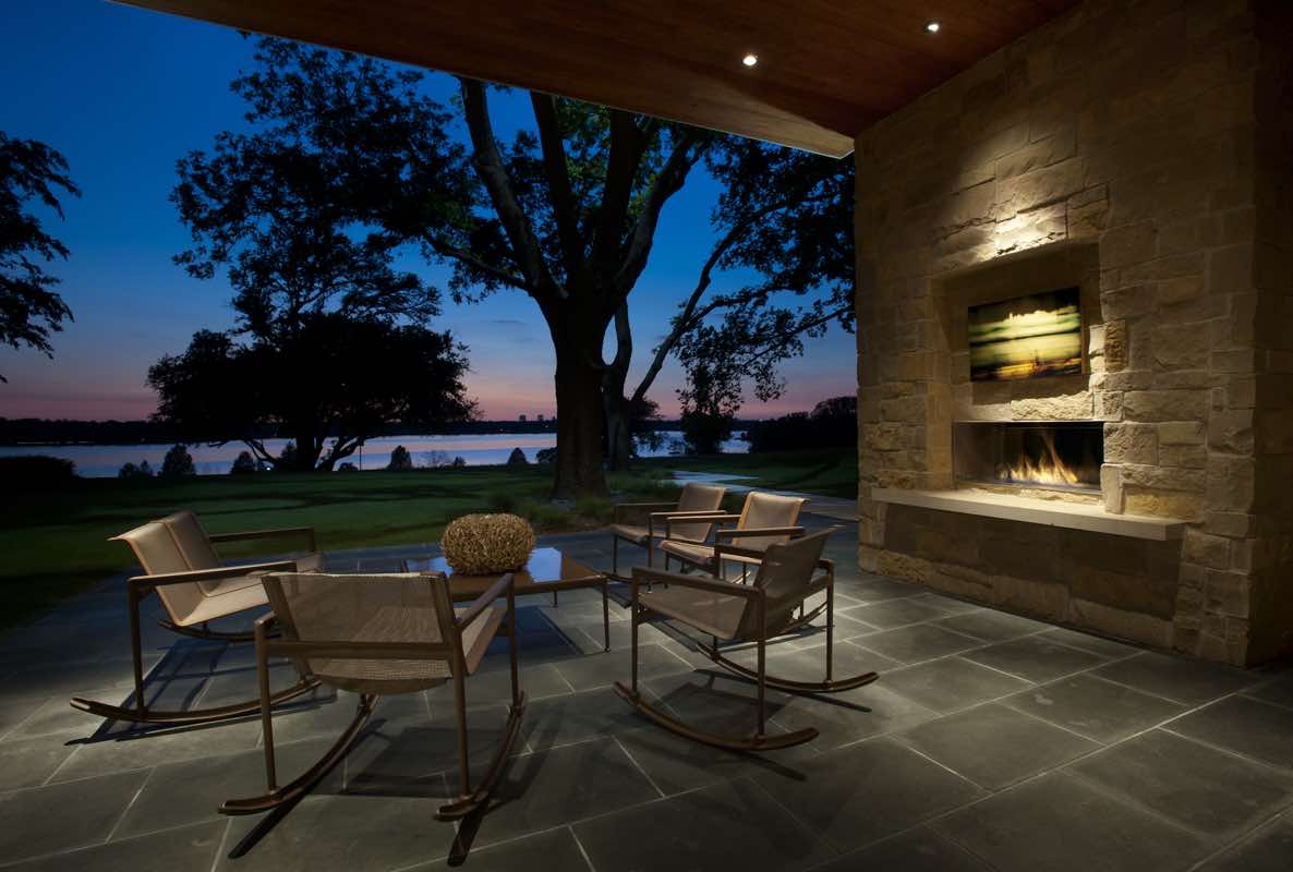 Urban Lake House outdoor lounge area with fireplace