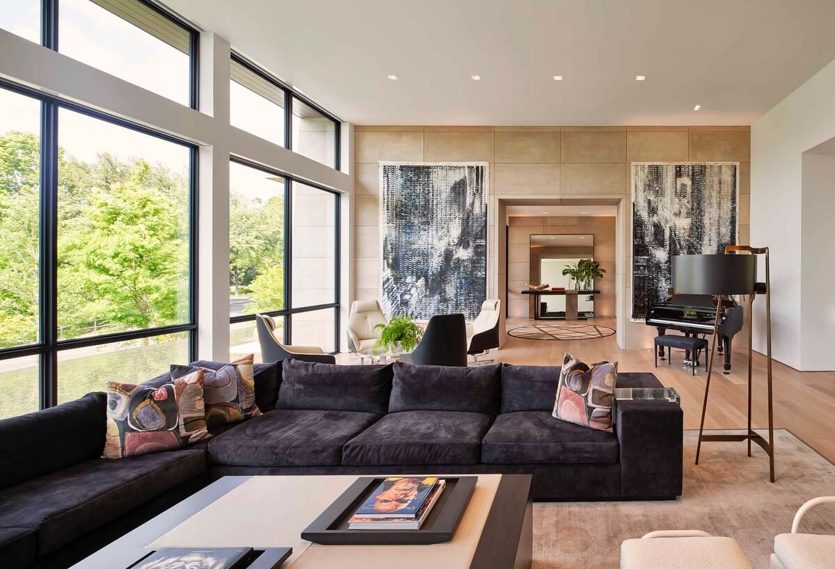 Living room with large gray velvet wraparound sofa