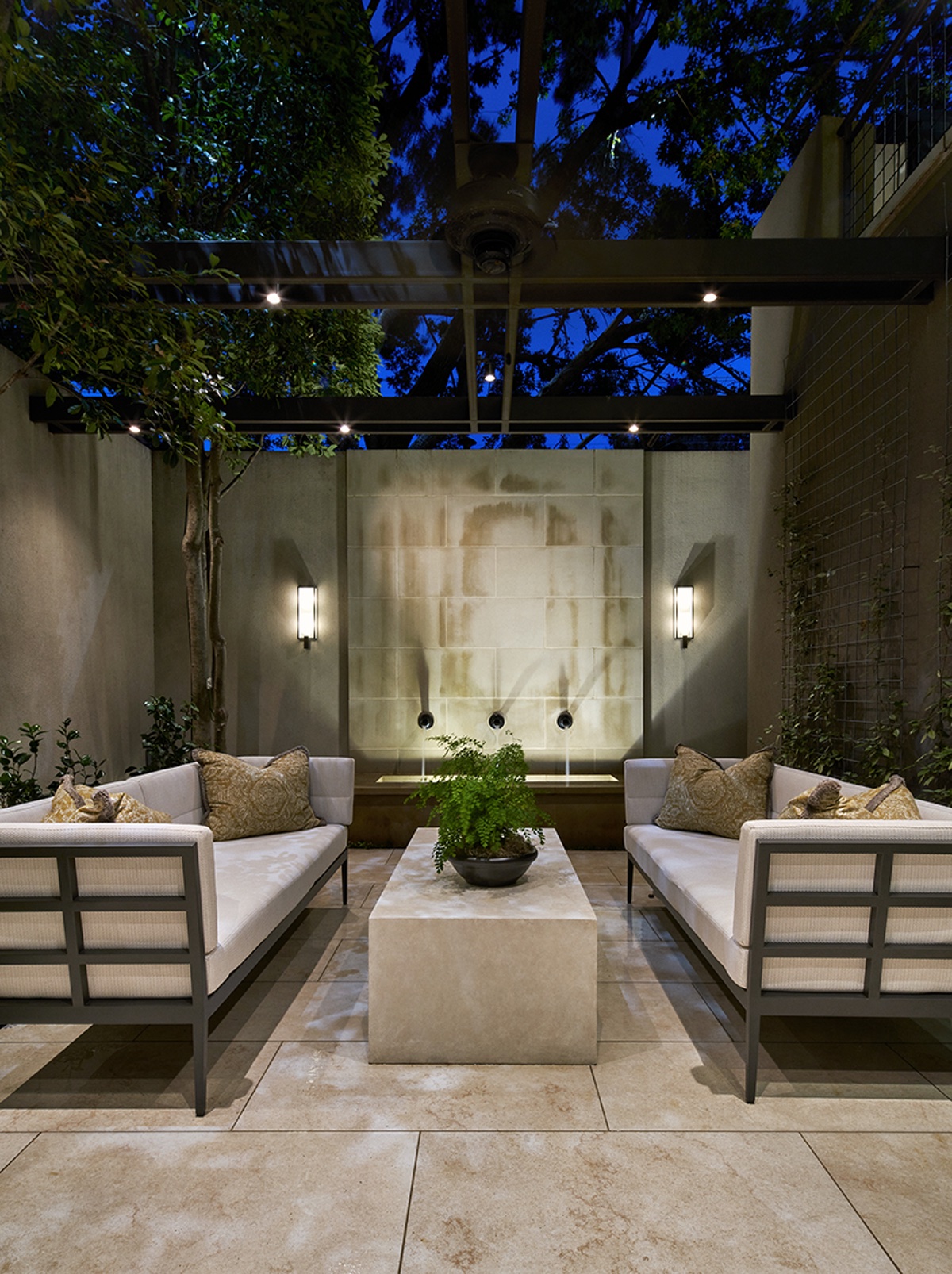 Outdoor seating area with wall fountain and outdoor sofas
