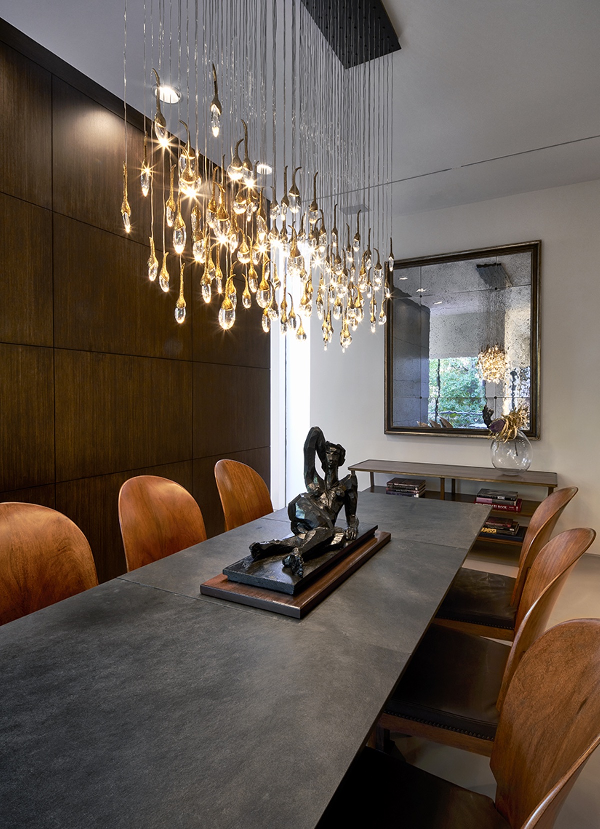 View of dining table with lights dangling from chandelier