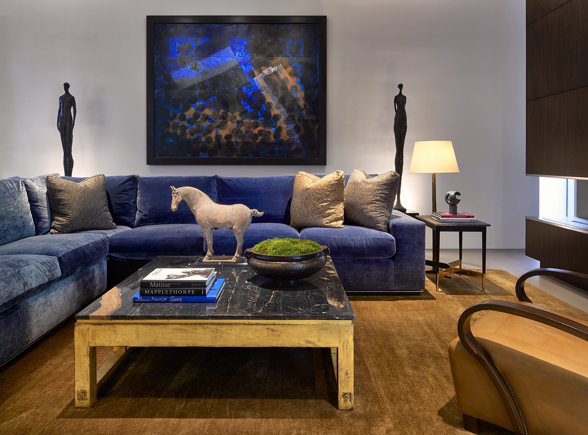 Living room seating area with blue mohair sofa and two Corbin Bronze statues