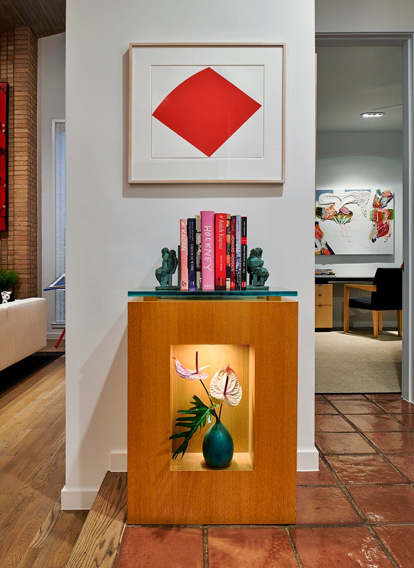 entry console table with art print above it