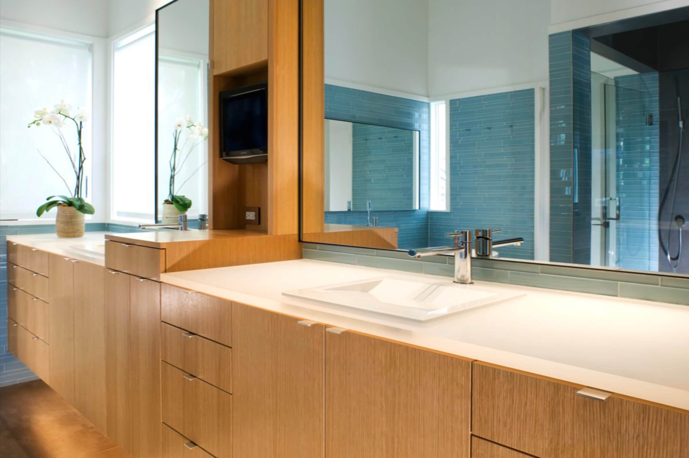 side view of dual sinks and wood cabinets in bathroom