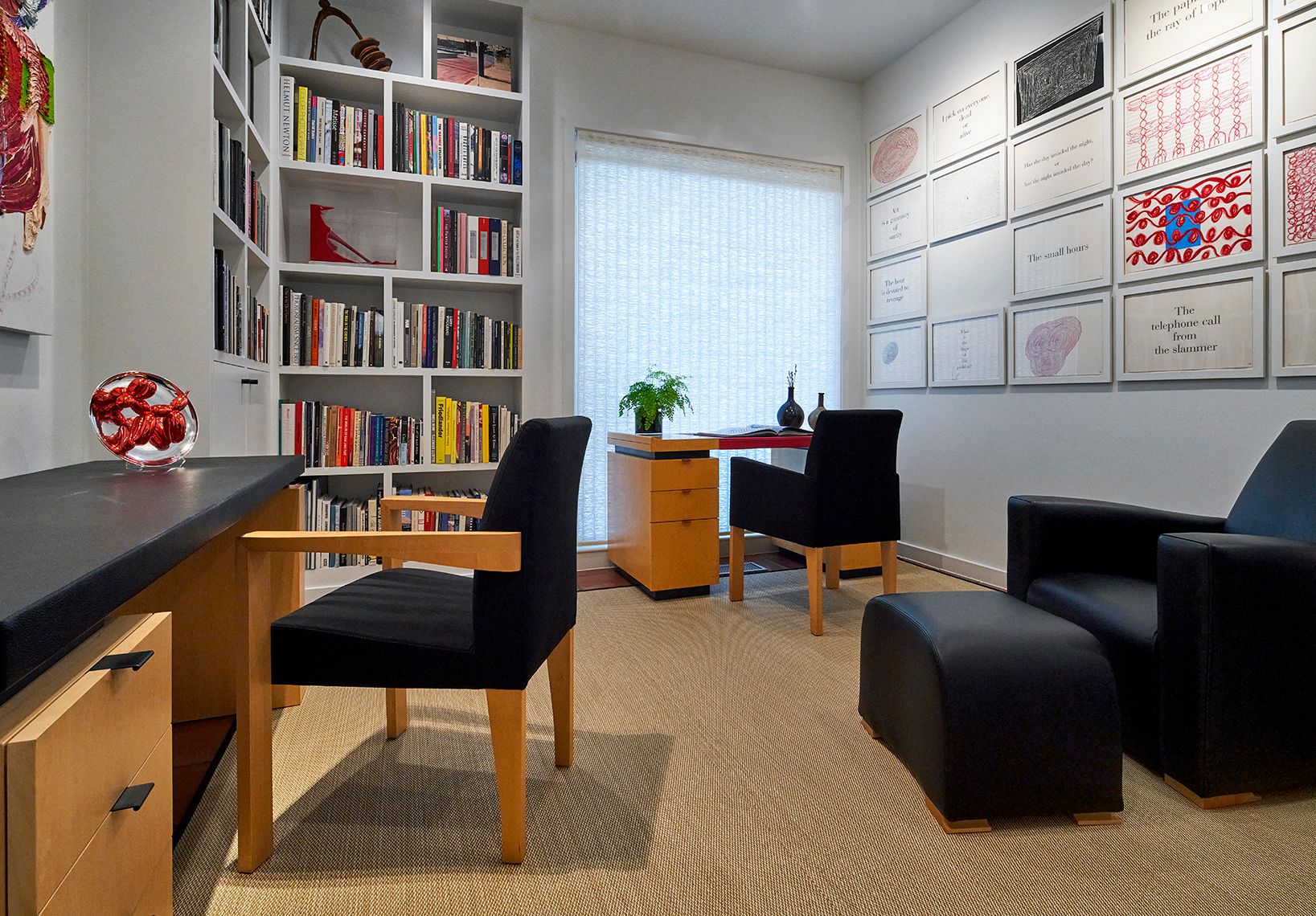 office area with dark furniture and white bookshelves